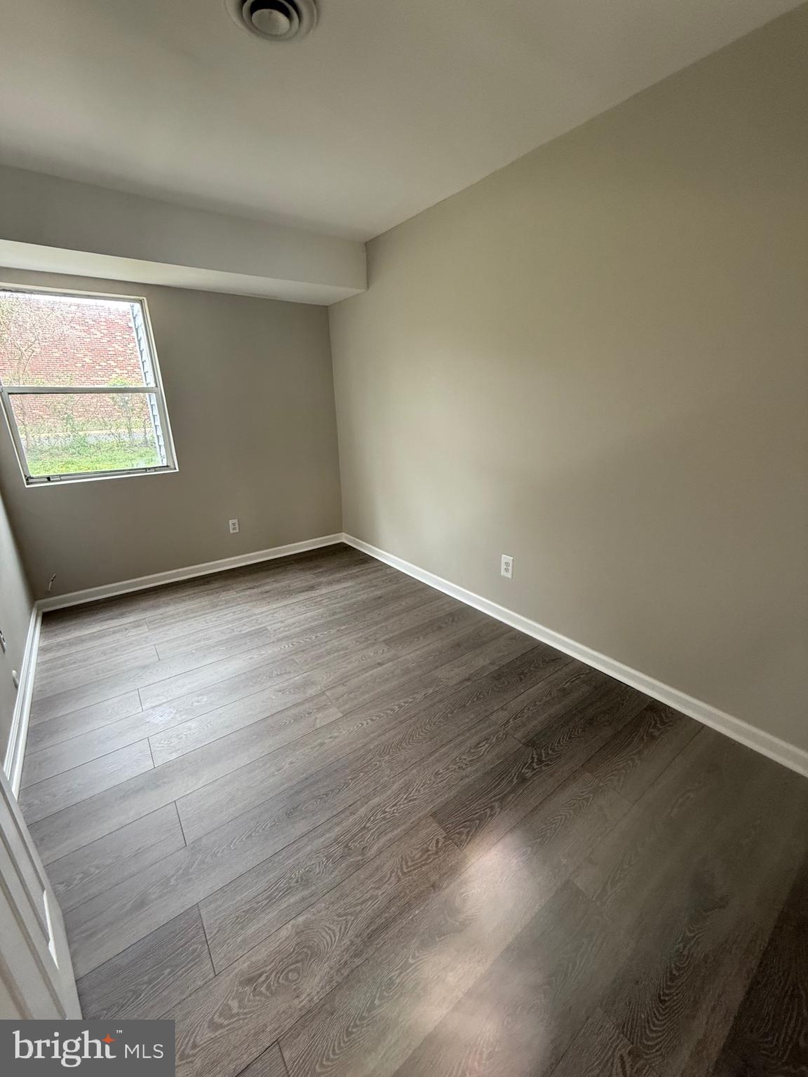 139 Spruance Road Dover, DE 19901 - Photo 17 of 20 an empty room with wooden floor and windows