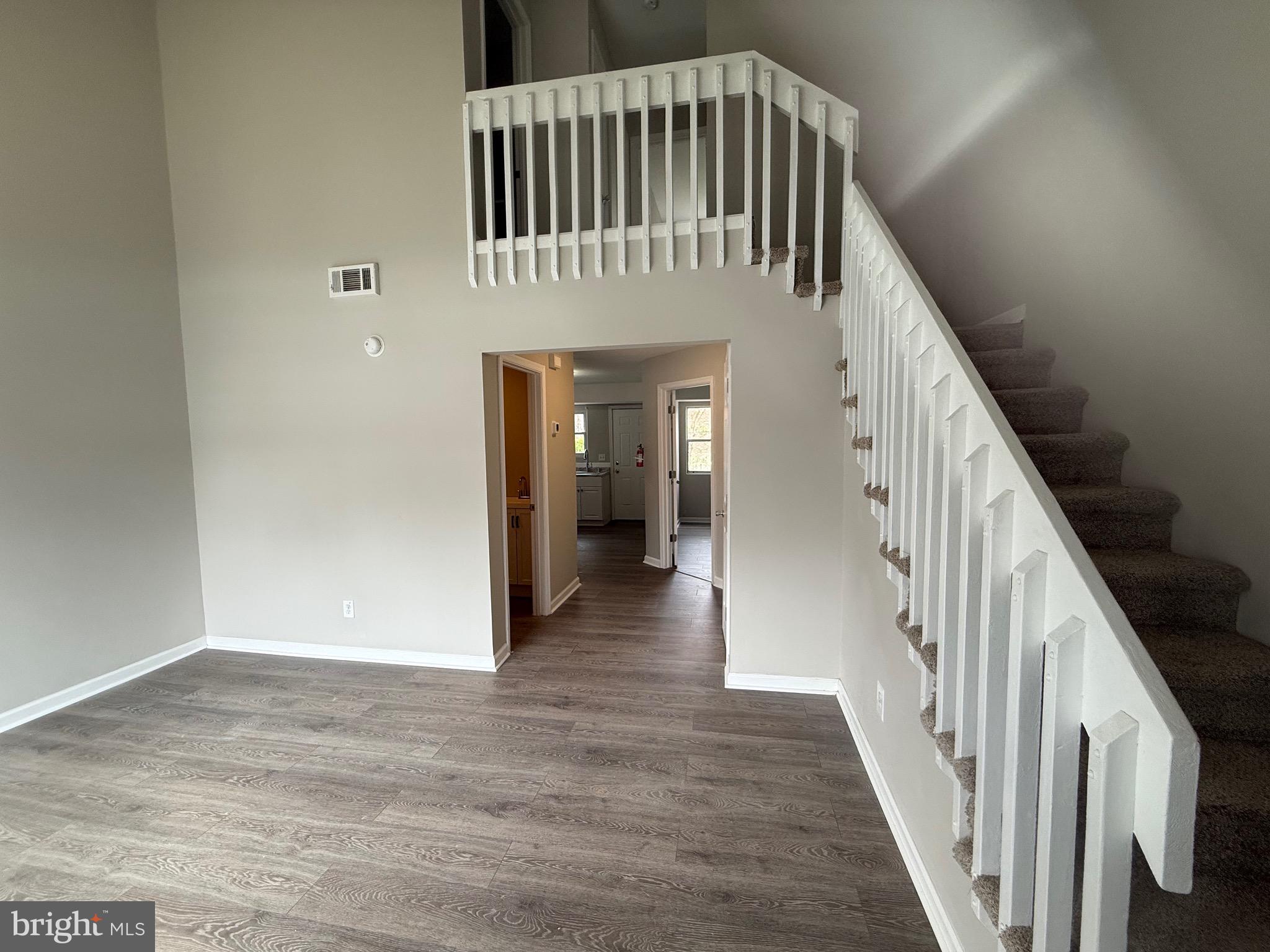 139 Spruance Road Dover, DE 19901 - Photo 2 of 20 a view of a hallway with wooden floor and staircase