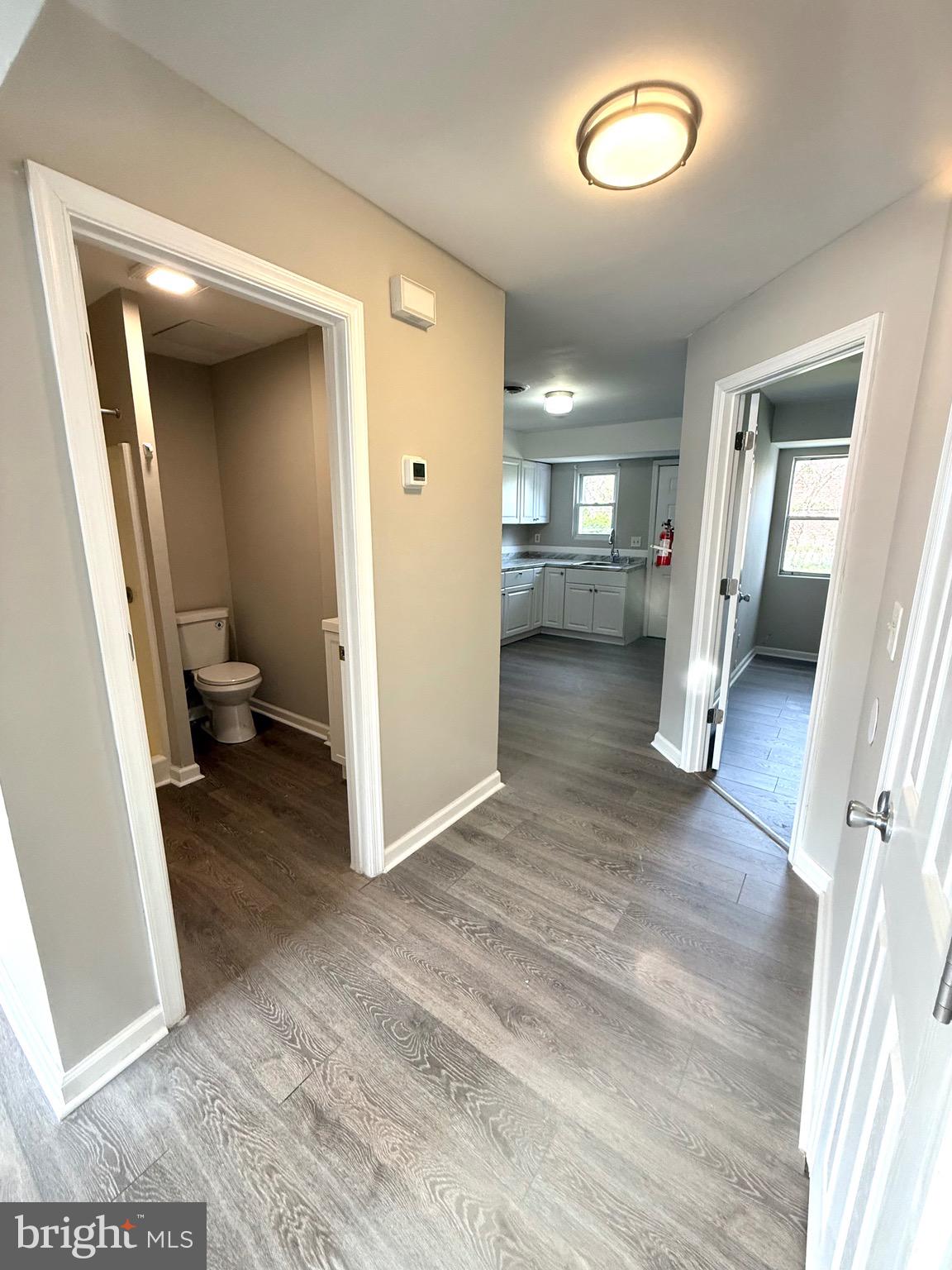 139 Spruance Road Dover, DE 19901 - Photo 6 of 20 a view of a hallway view with wooden floor and staircase