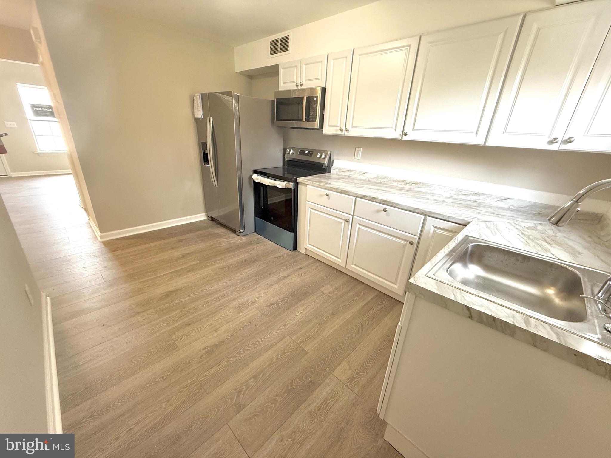 139 Spruance Road Dover, DE 19901 - Photo 7 of 20 a kitchen with stainless steel appliances granite countertop a sink stove and refrigerator