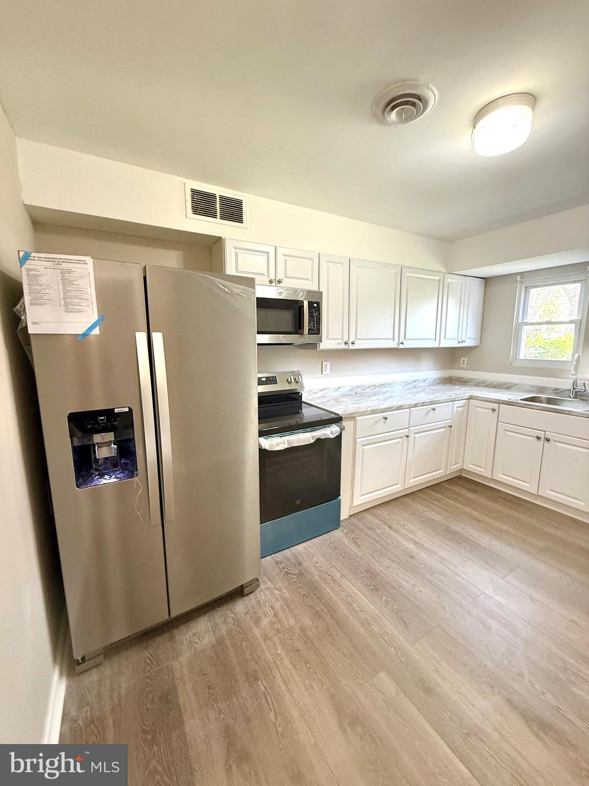 139 Spruance Road Dover, DE 19901 - Photo 8 of 20 a kitchen with stainless steel appliances a refrigerator sink and microwave