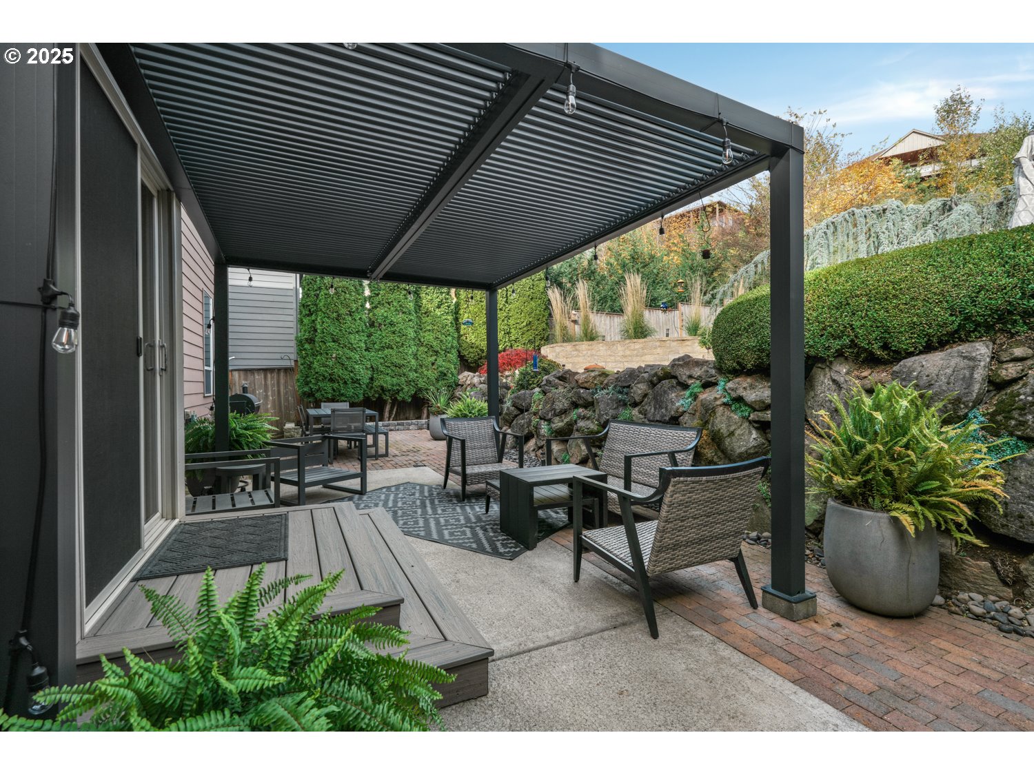 3561 Z Street Washougal, WA 98671 - Photo 33 of 41 a view of a patio with table and chairs potted plants with floor to ceiling window