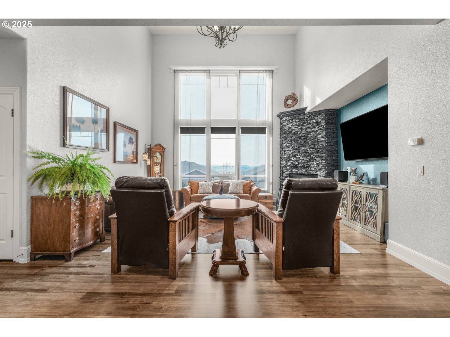 3561 Z Street Washougal, WA 98671 - Photo 5 of 41 a living room with furniture a flat screen tv and a floor to ceiling window