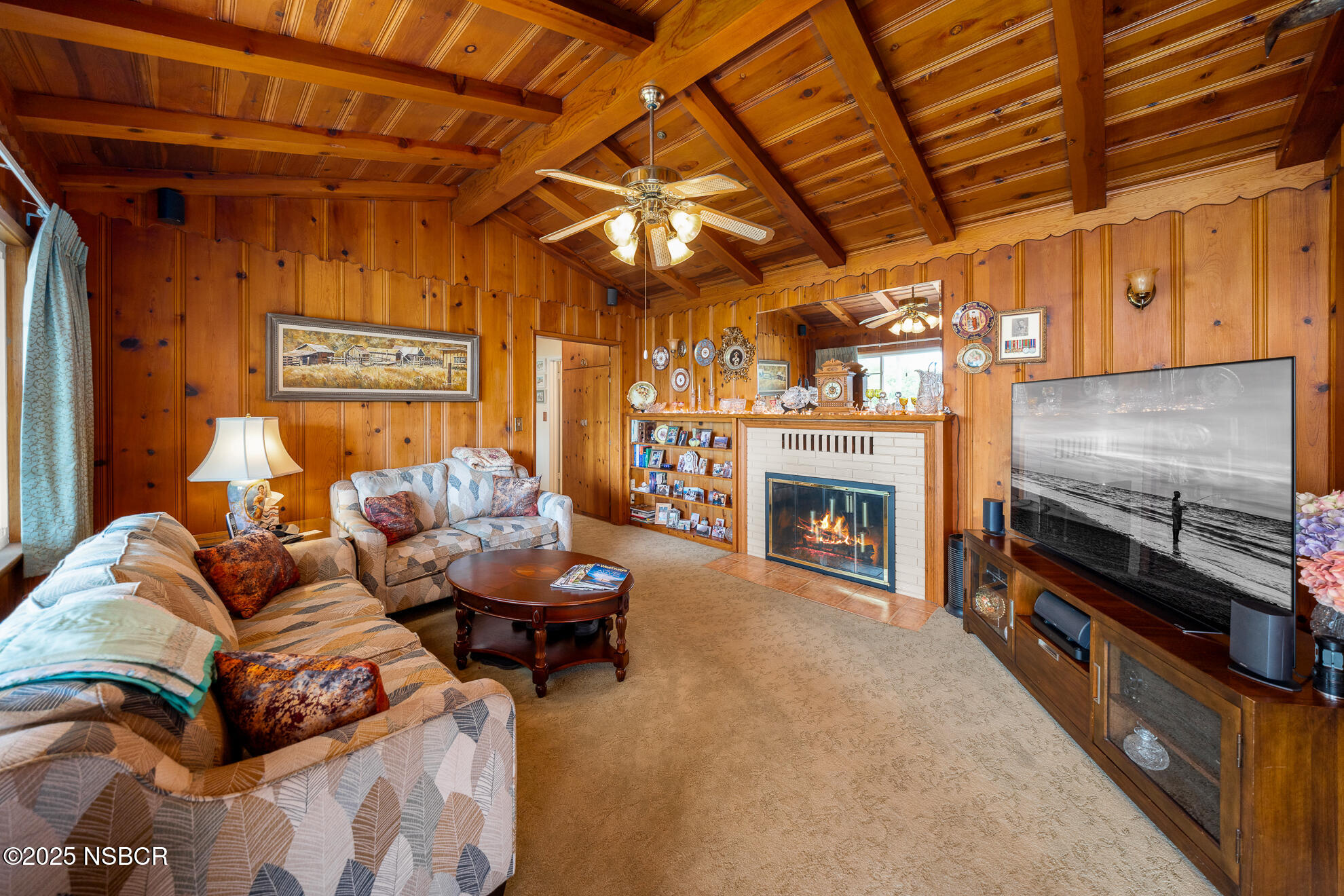 4314 West Ocean Avenue Lompoc, CA 93436 - Photo 17 of 58 a living room with furniture a fireplace and a flat screen tv