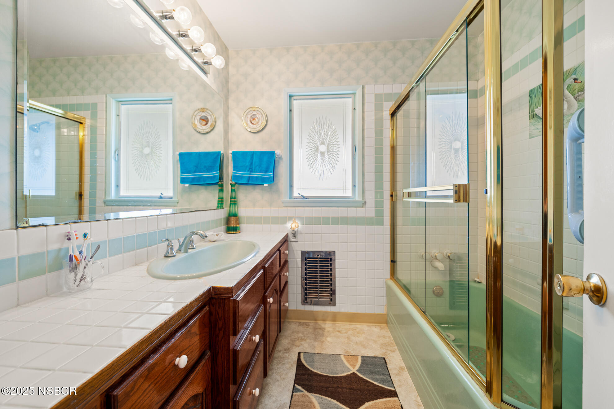 4314 West Ocean Avenue Lompoc, CA 93436 - Photo 28 of 58 a bathroom with a sink a mirror and a shower