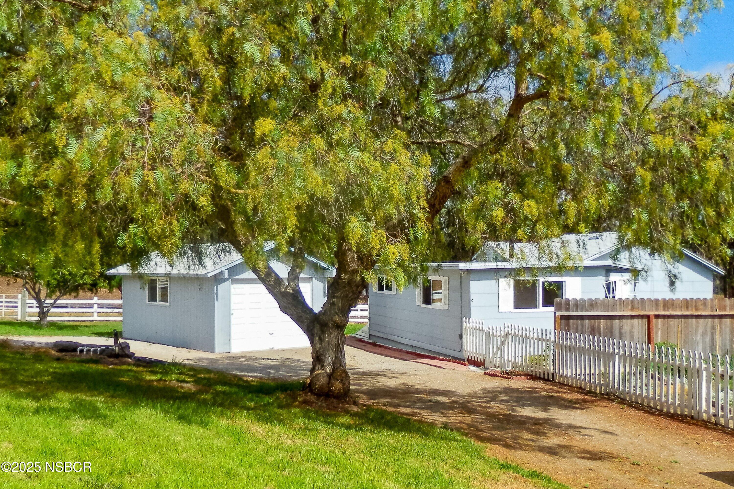 4314 West Ocean Avenue Lompoc, CA 93436 - Photo 39 of 58 a view of a house with a yard and a tree