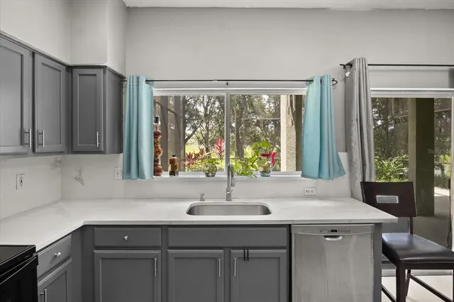 a kitchen with a sink and large window
