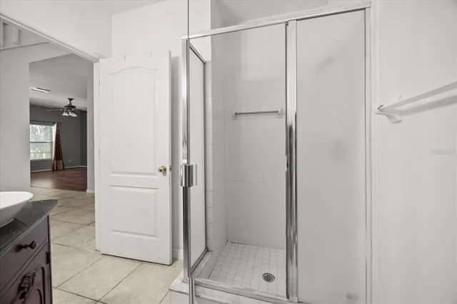 a bathroom with a glass shower door