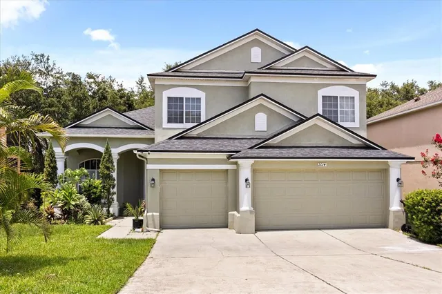 a front view of a house with a yard and garage