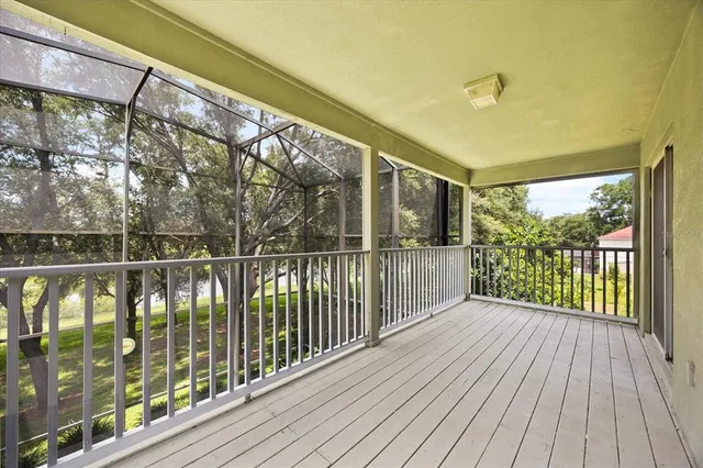 a view of a balcony with wooden floor