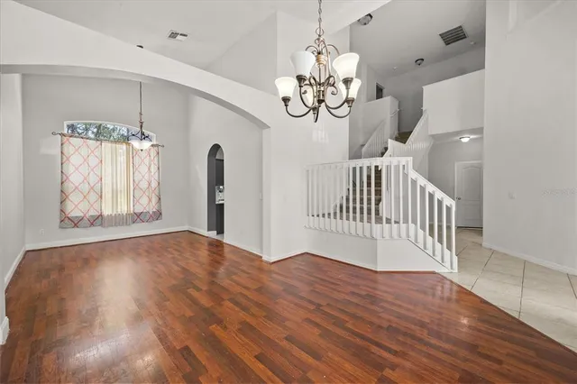 a view of a livingroom with wooden floor and chandelier