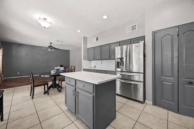 a kitchen with a stove a refrigerator and a sink