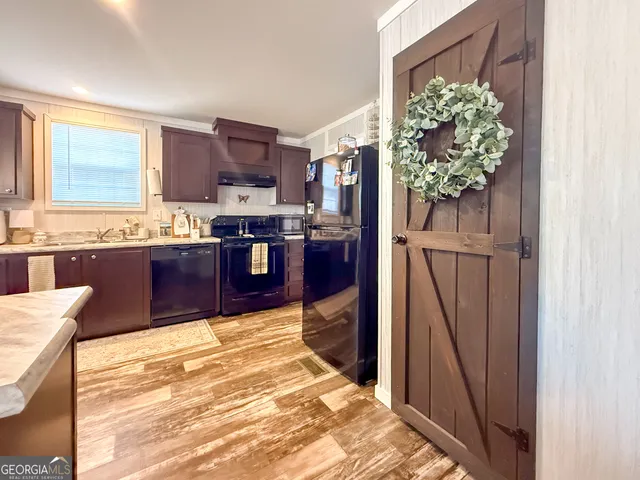 a kitchen with stainless steel appliances granite countertop a refrigerator and a stove