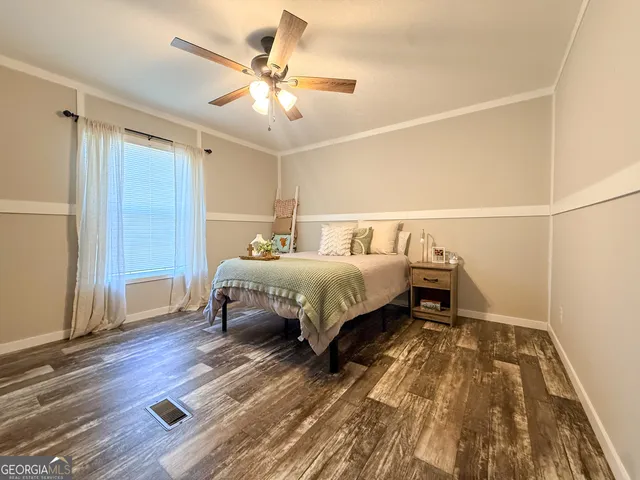 a bedroom with a bed and a ceiling fan