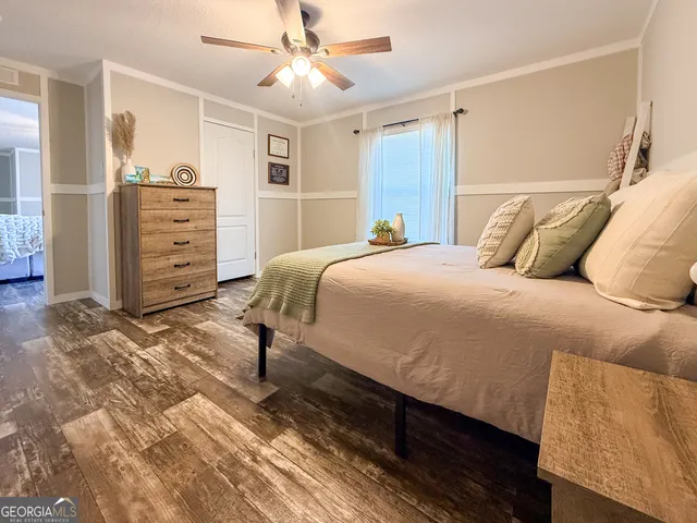 a bedroom with a bed and wooden floor
