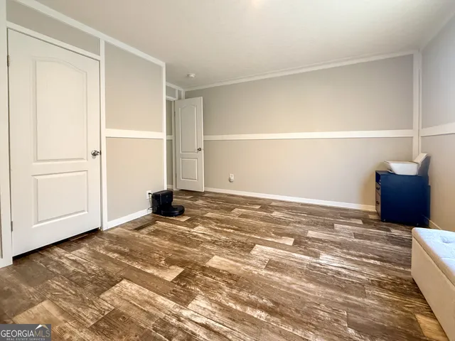 a view of a livingroom with wooden floor and cabinet
