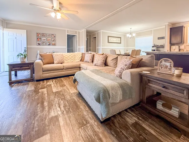 a large bedroom with a bed and wooden floor