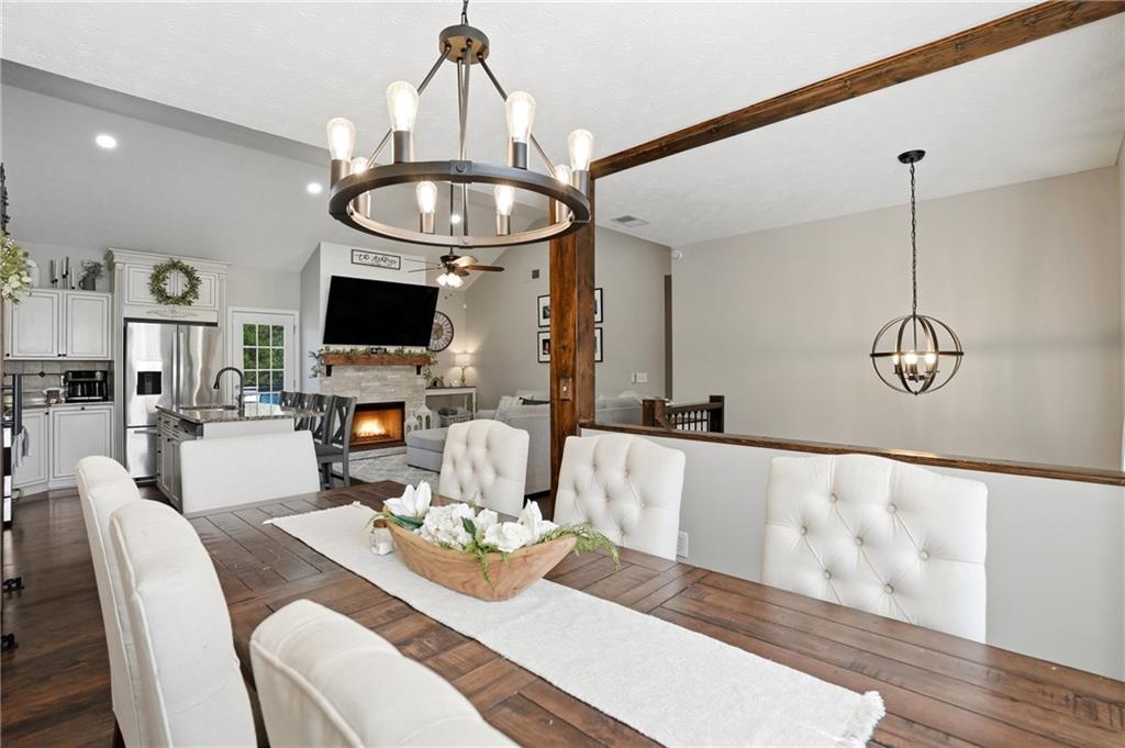 378 Baugh Street Commerce, GA 30529 - Photo 14 of 35 a living room with furniture a dining table and a chandelier