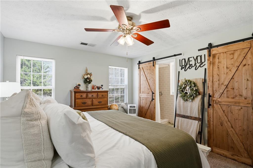 378 Baugh Street Commerce, GA 30529 - Photo 15 of 35 a bedroom with a bed and a window
