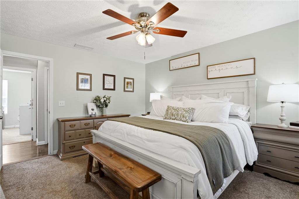 378 Baugh Street Commerce, GA 30529 - Photo 17 of 35 a bedroom with a bed and a chandelier