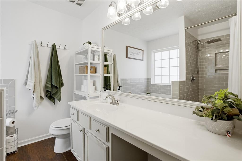 378 Baugh Street Commerce, GA 30529 - Photo 18 of 35 a bathroom with a sink a toilet and a mirror