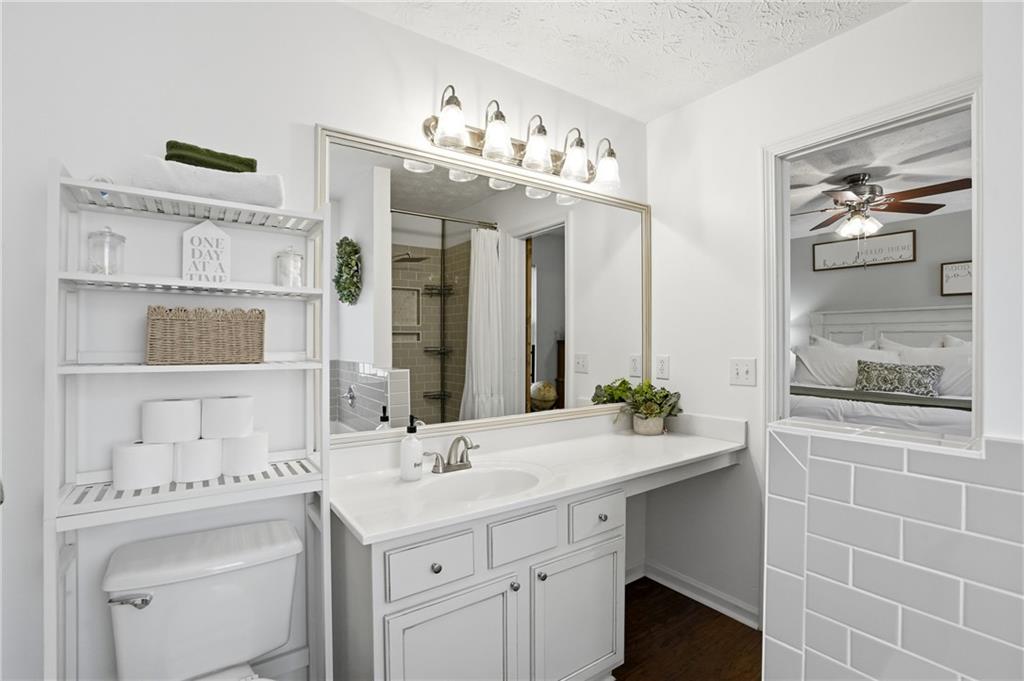 378 Baugh Street Commerce, GA 30529 - Photo 19 of 35 a bathroom with a sink vanity mirror and toilet