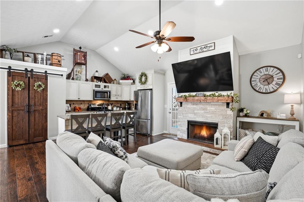 378 Baugh Street Commerce, GA 30529 - Photo 2 of 35 a living room with furniture a flat screen tv and a fireplace