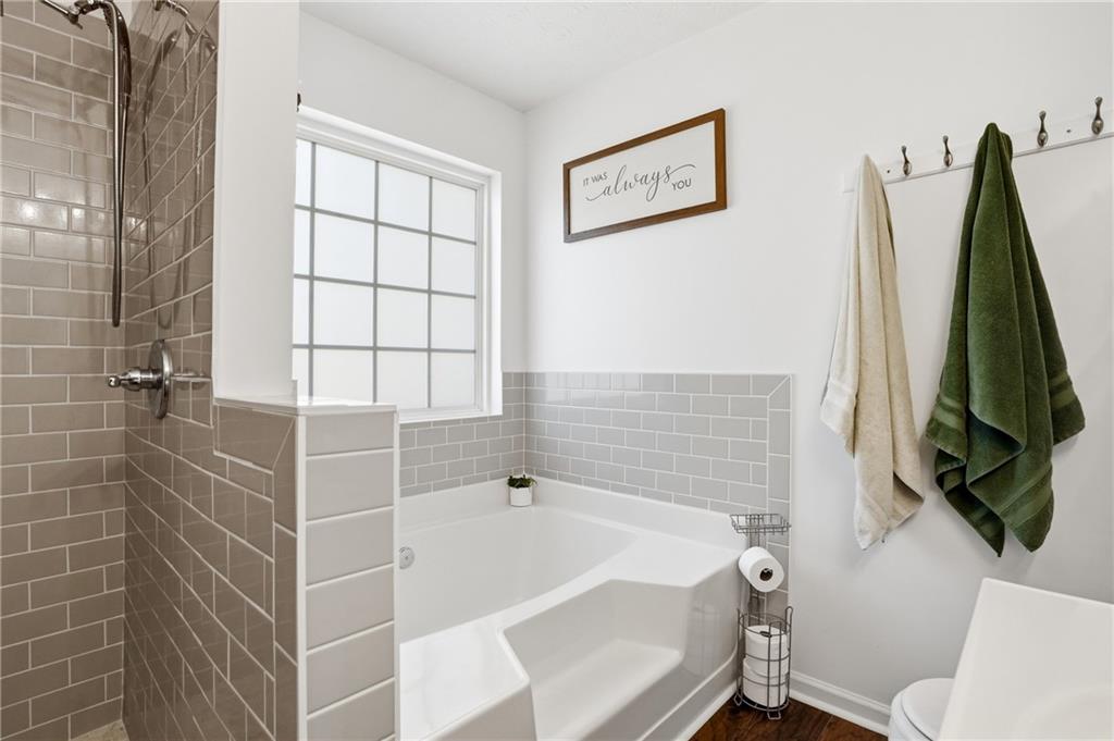 378 Baugh Street Commerce, GA 30529 - Photo 21 of 35 a bathroom with a tub and a shower