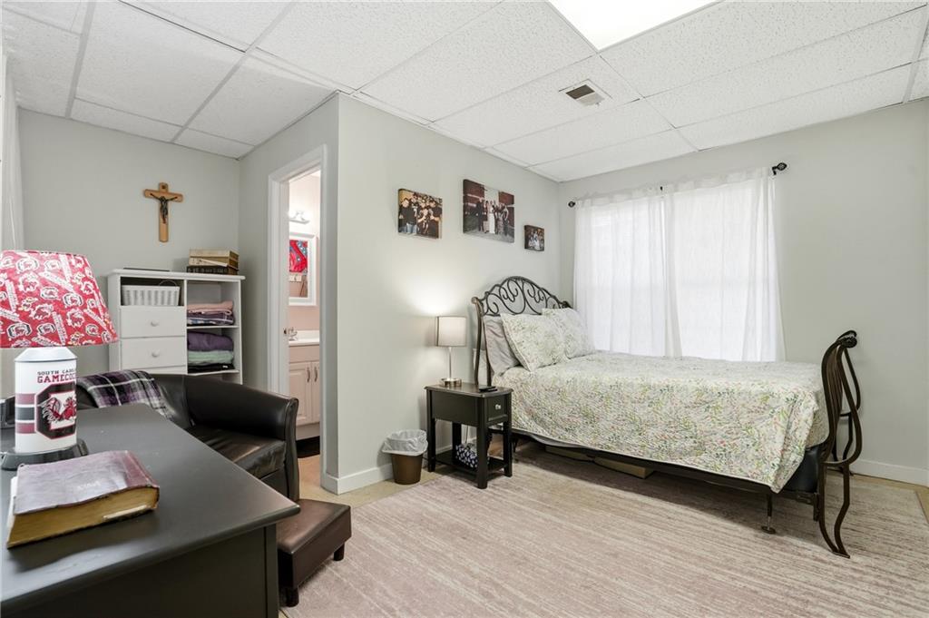 378 Baugh Street Commerce, GA 30529 - Photo 25 of 35 a bedroom with furniture and a wooden floor