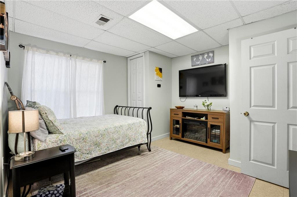 378 Baugh Street Commerce, GA 30529 - Photo 26 of 35 a bedroom with a bed and a flat tv screen on wall