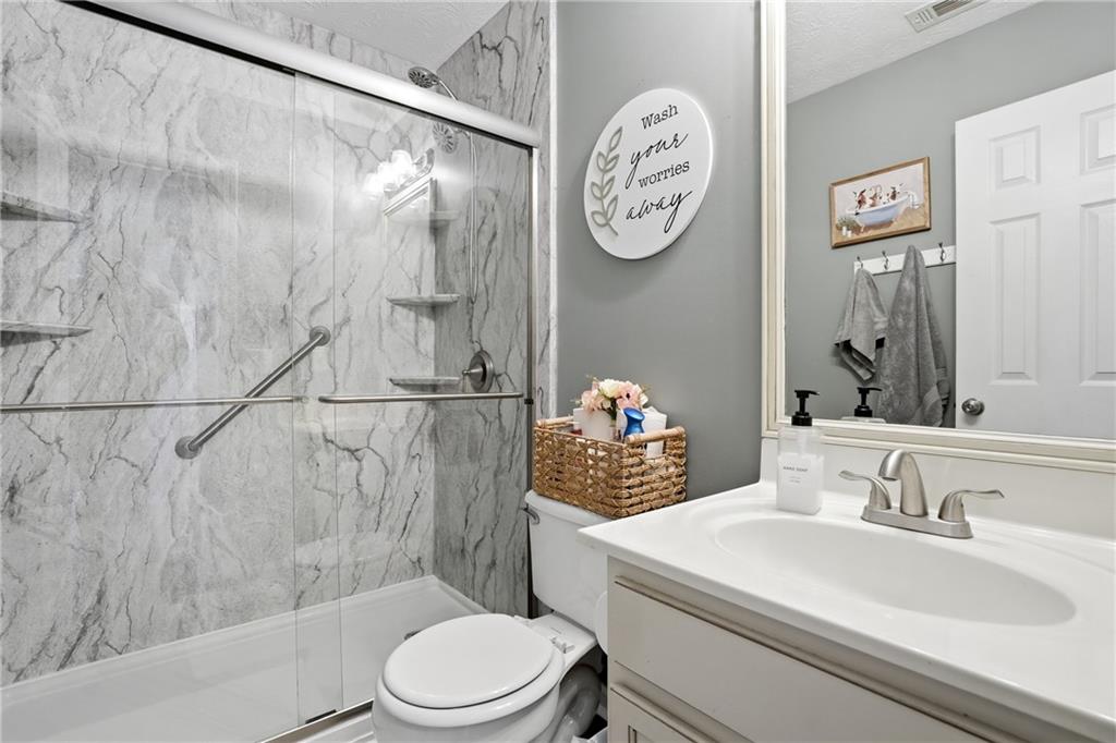 378 Baugh Street Commerce, GA 30529 - Photo 5 of 35 a bathroom with a toilet sink and mirror