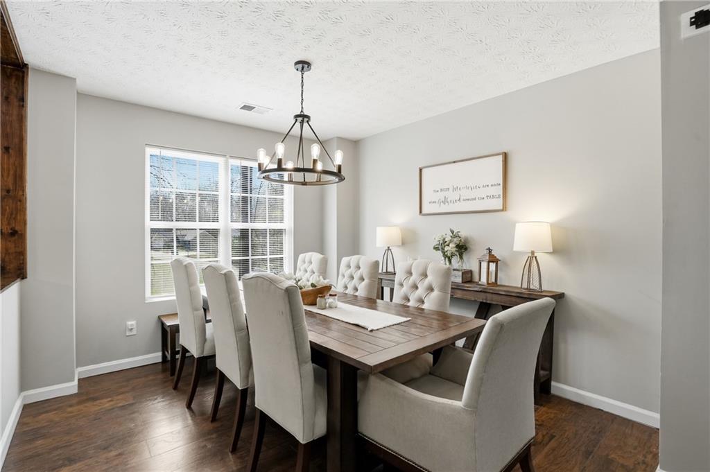 378 Baugh Street Commerce, GA 30529 - Photo 7 of 35 a view of a dining room with furniture window and wooden floor