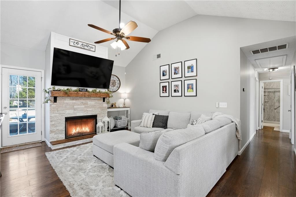378 Baugh Street Commerce, GA 30529 - Photo 8 of 35 a living room with furniture a flat screen tv and a fireplace