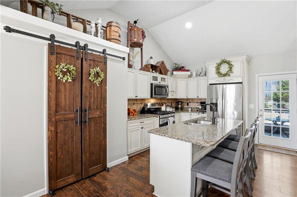 378 Baugh Street Commerce, GA 30529 - Photo 10 of 35 a kitchen with stainless steel appliances granite countertop a refrigerator and a stove top oven