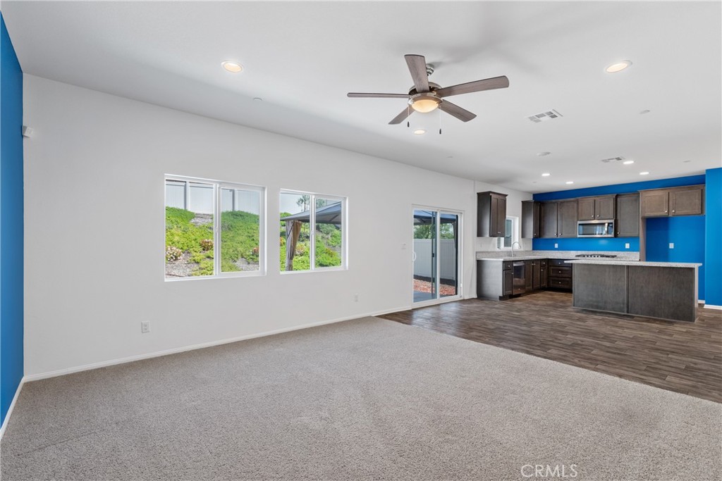 11738 Murray Way Beaumont, CA 92223 - Photo 11 of 45 a view of an empty room with kitchen view and a window