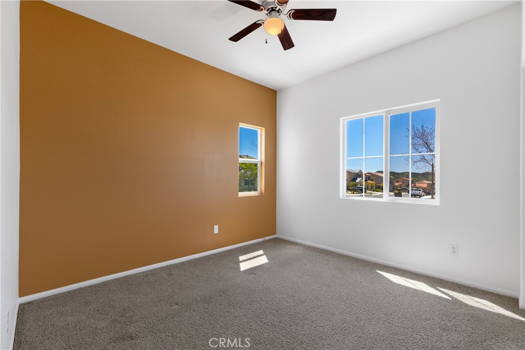 11738 Murray Way Beaumont, CA 92223 - Photo 14 of 45 an empty room with a window and a ceiling fan