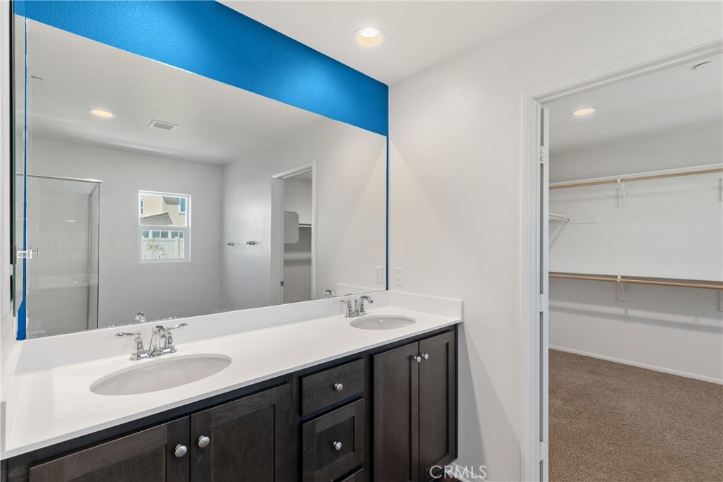 11738 Murray Way Beaumont, CA 92223 - Photo 21 of 45 a bathroom with a double vanity sink and a mirror