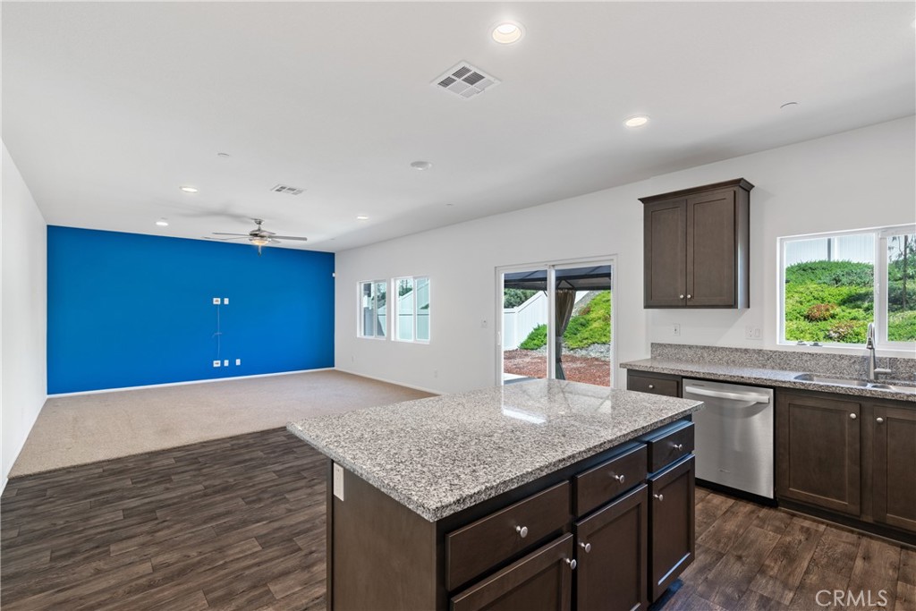 11738 Murray Way Beaumont, CA 92223 - Photo 10 of 45 a kitchen with a sink a window and wooden cabinets