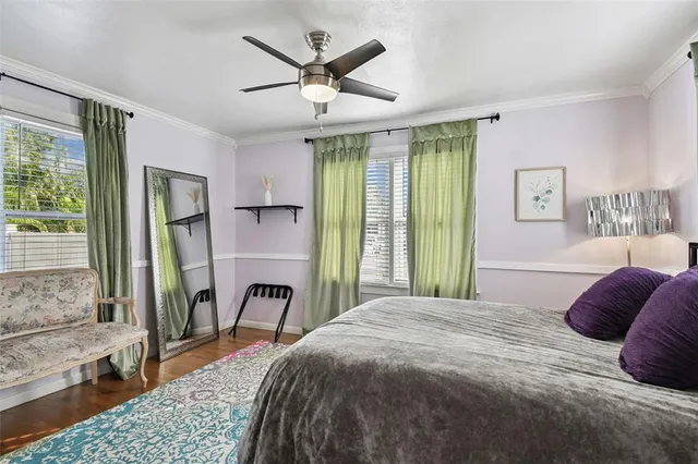 a bedroom with a large bed and a chandelier