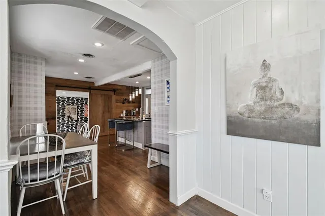 a kitchen with a dining table chairs stove and cabinets