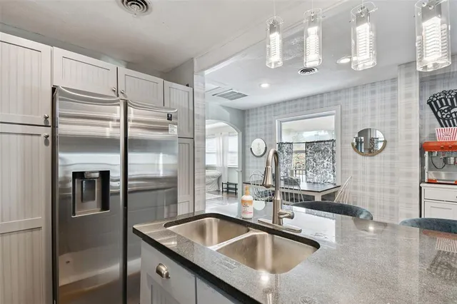 a kitchen with stainless steel appliances a stove sink and cabinets