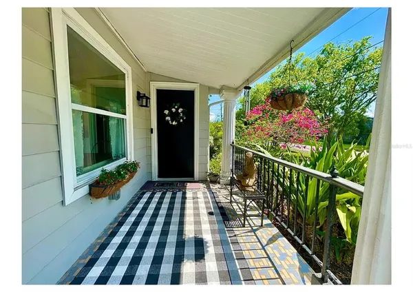 a balcony with beautiful flowers and wooden floor