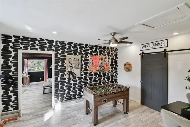 a view of a workspace with furniture and wooden floor