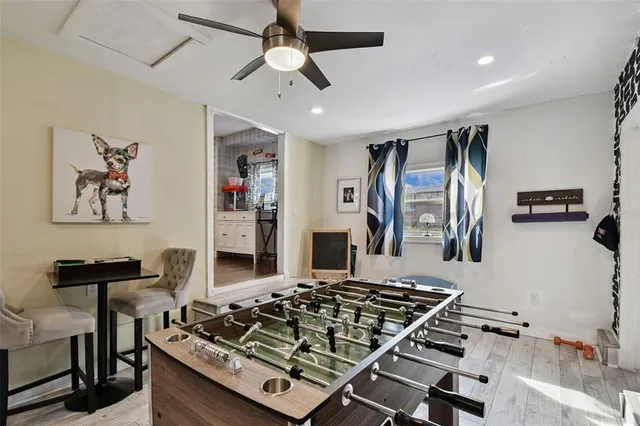 a bedroom with a bed a mirror and furniture