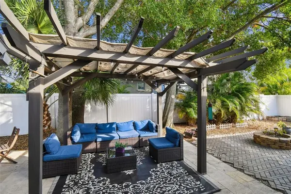 a view of a white and patio with a table and chairs