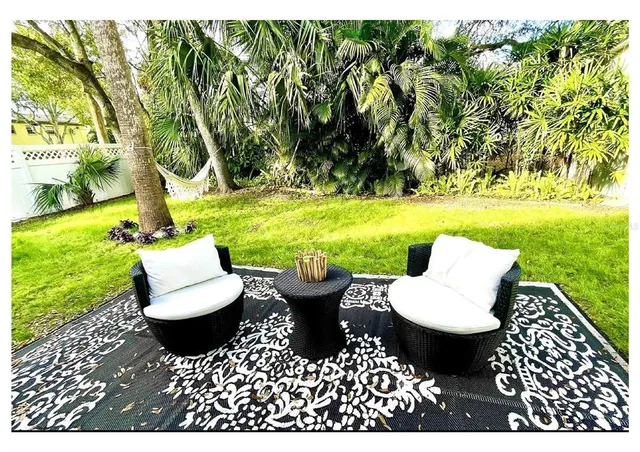 an aerial view of residential houses with outdoor space and trees