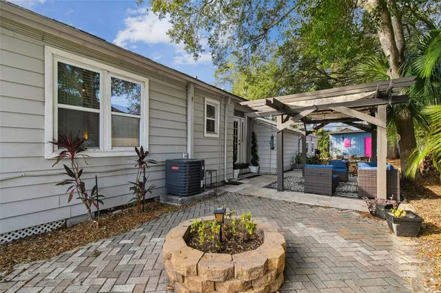an aerial view of residential houses with outdoor space and trees