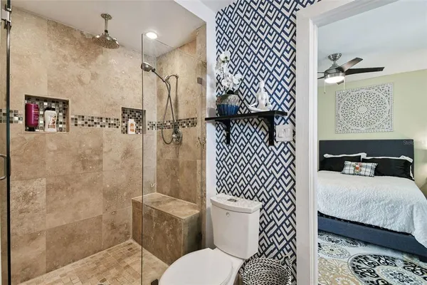 a bathroom with a sink toilet and shower