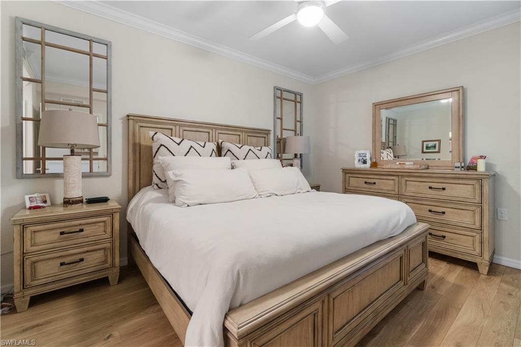 9834 Giaveno Circle, Unit 1726 Naples, FL 34113 - Photo 12 of 20 a bedroom with a bed and a dresser