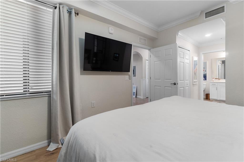 9834 Giaveno Circle, Unit 1726 Naples, FL 34113 - Photo 13 of 20 a large white bed in a white room